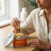 Woman selecting a Boost CBD mushroom gummy from an open tin